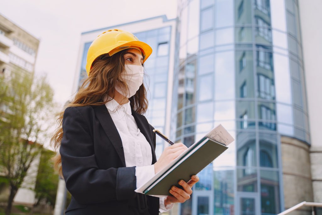 Female architect with construction site on the background